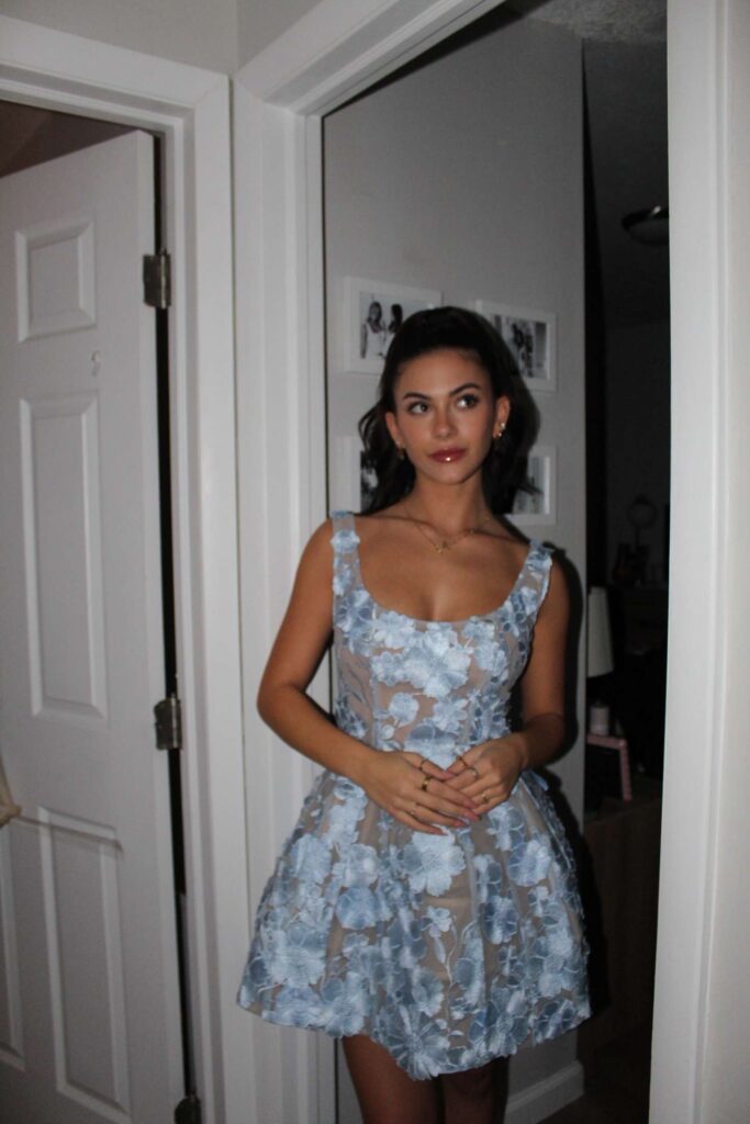 Mia in a beautiful blue dress and ponytail